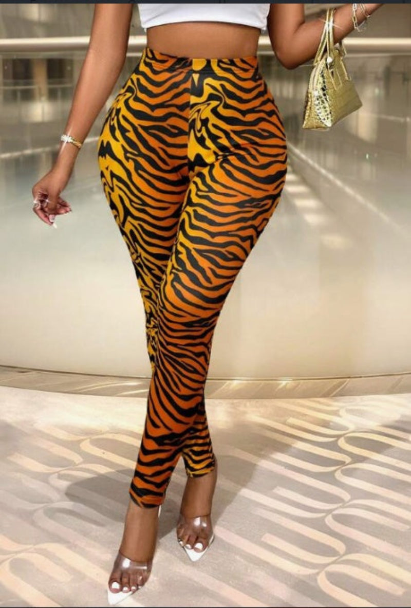 A pair of slim fit stretchy leggings with a colorblock pattern in beige, black, and brown.