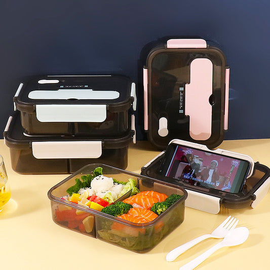 lunch box with food and phone on a table