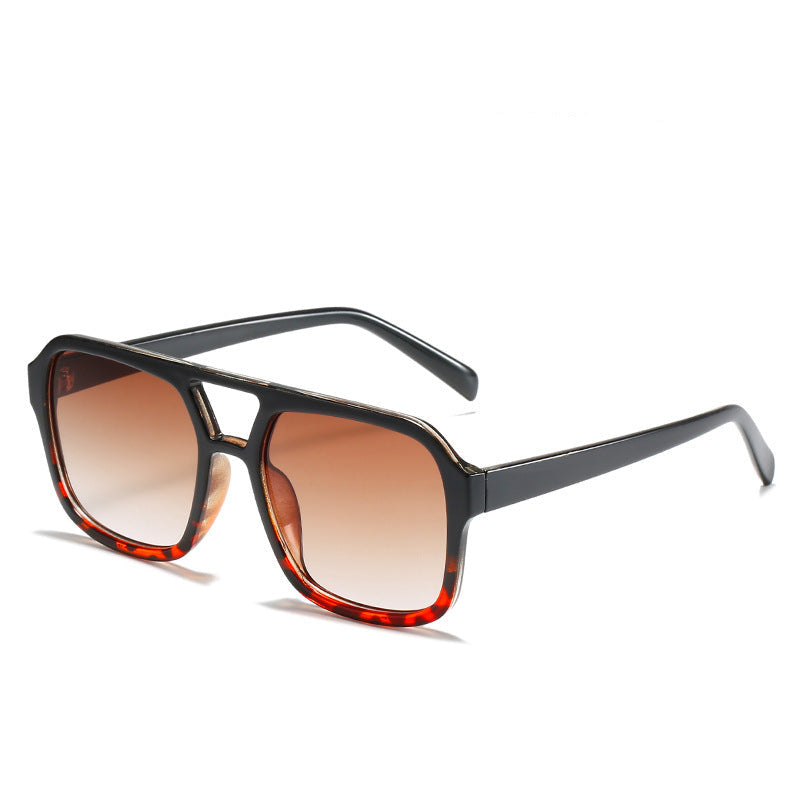 Sunglasses with black frame and brown gradient lenses on a white background, labeled 'Black Leopard'.
