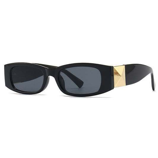 Black sunglasses with gold accents on a white background