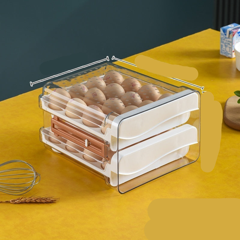 A set of white, double-layered egg storage boxes with a transparent front panel, stacked on top of each other, with a few eggs visible inside the top box.