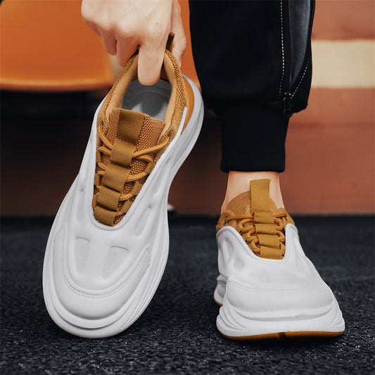 White sneakers with brown accents worn by a person on a blurred background