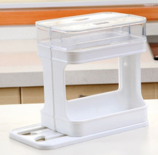 White kitchen utensil holder with a transparent container on a wooden surface