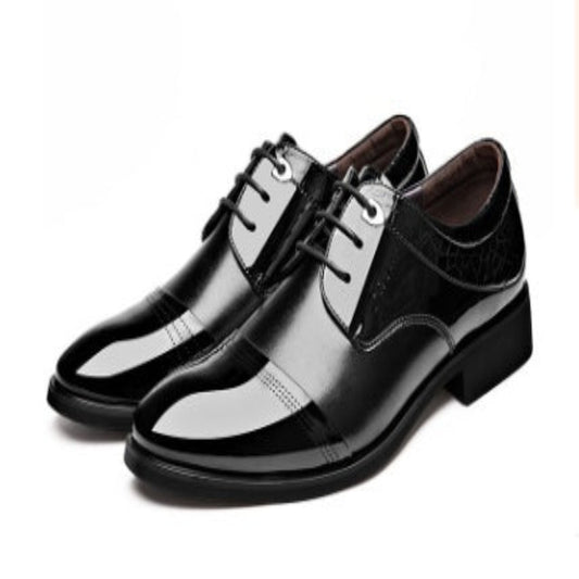 Black dress shoes with glossy finish on a white background
