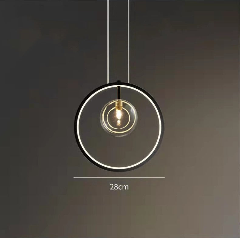 Modern bubble chandelier with a contemporary design, featuring glass pendant lamps over a dining table in a stylish kitchen setting.