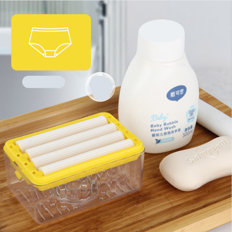 Baby care products including a bottle of baby bubble hand wash, a container of baby wipes, and a soap bar on a wooden surface.