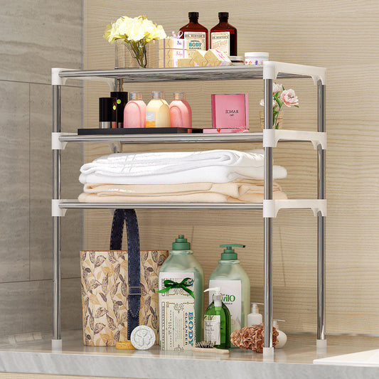 Metal shelving unit with folded clothes, bags, and various items on a neutral background