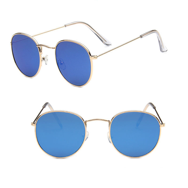 Round sunglasses with gold frames and blue lenses on a white background