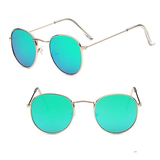 Gold-framed sunglasses with green lenses on a white background