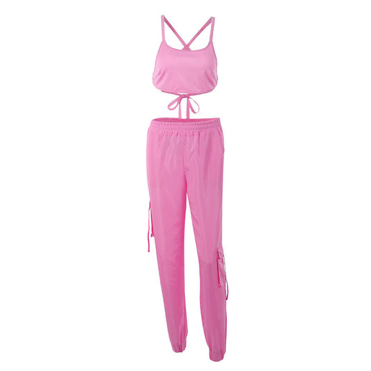 Pink sports outfit with tank top and pants on a white background