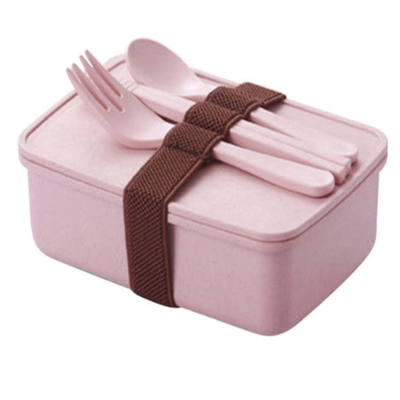 A set of bamboo fiber lunch boxes in beige, green, and pink colors with brown straps.