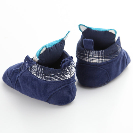 Pair of blue baby shoes with plaid interior on a white background
