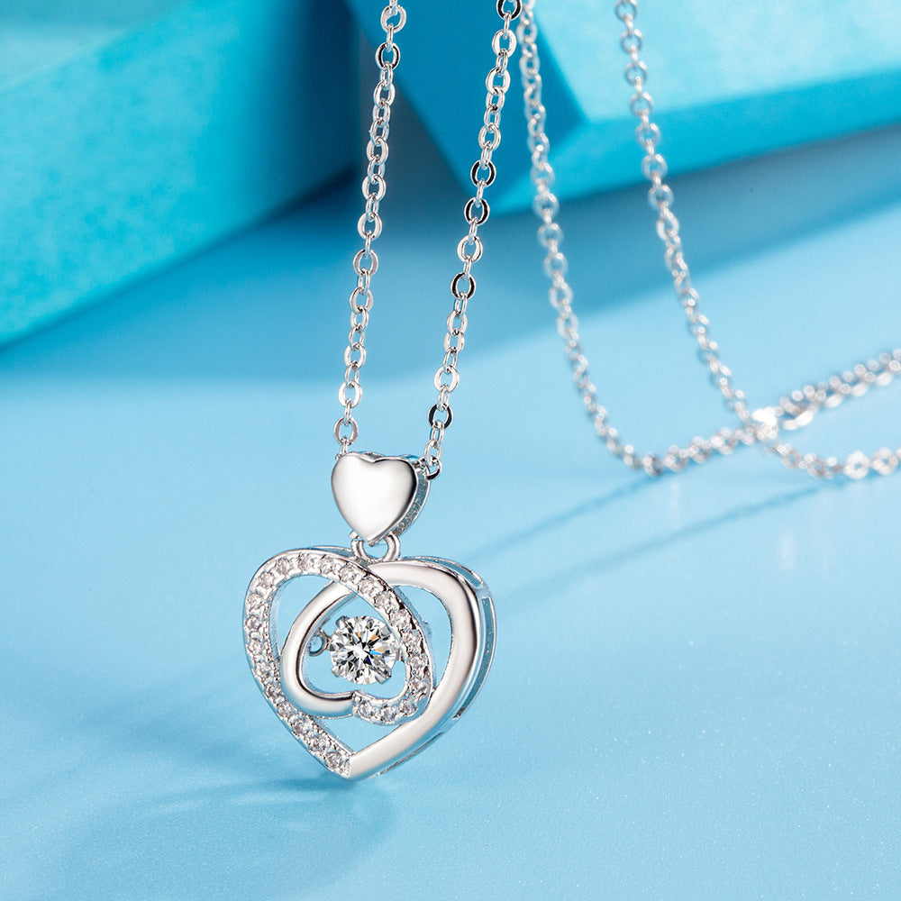 Silver heart-shaped pendant necklace on a blue background