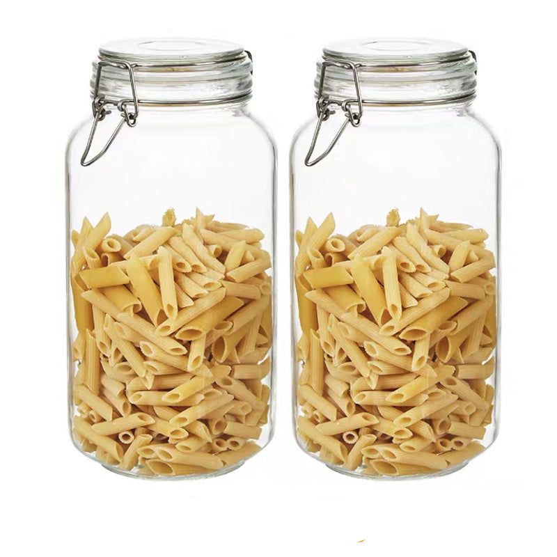 Two glass jars filled with penne pasta on a white background