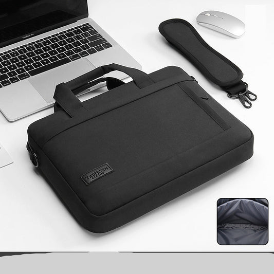 Black laptop bag with a laptop, mouse, and strap on a white background