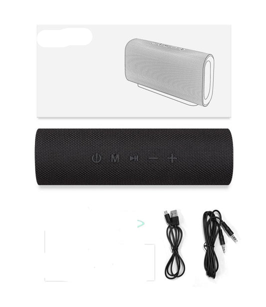 Black portable speaker with packaging, cables, and manuals on a white background