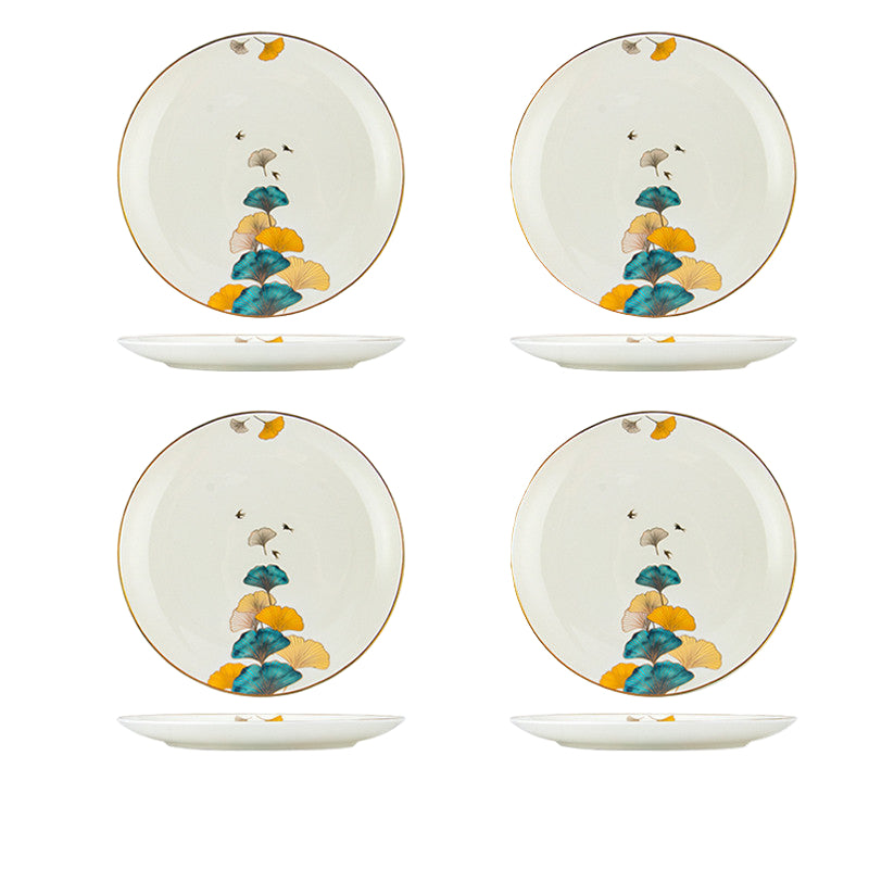 Set of four ceramic plates with decorative design on a white background