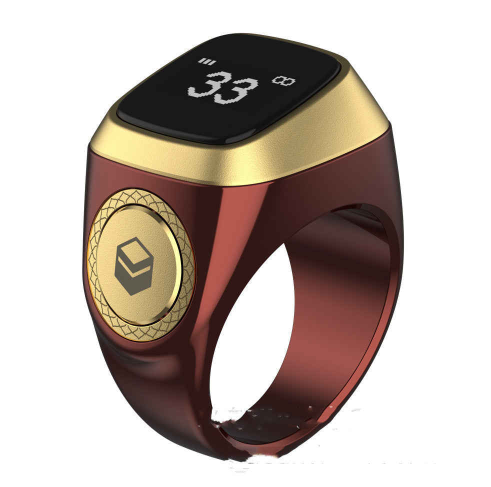 Gold and red smart ring with digital display on a white background