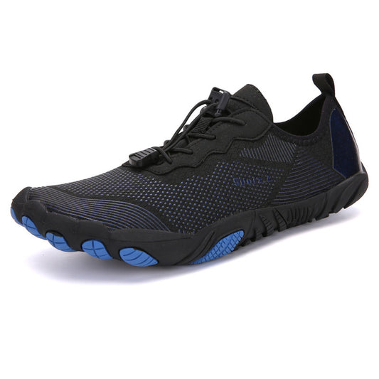Black athletic shoe with blue sole on a white background