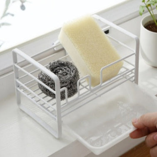 Kitchen sink caddy with sponge and scrubber on a kitchen counter