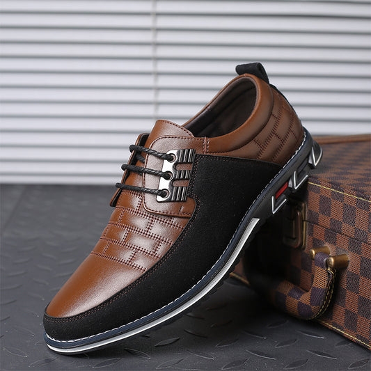 Brown and black leather shoes with a checkered pattern on a textured surface.