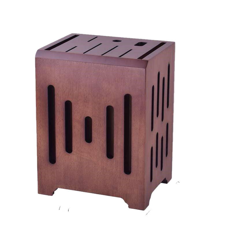 A brown wooden knife holder with multiple slots, containing various kitchen knives, placed on a table with a partial view of a kitchen in the background.