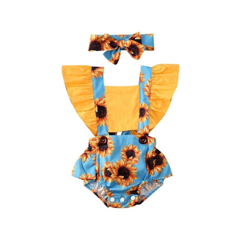 Baby romper with sunflower pattern, yellow top, and blue overalls on a white background