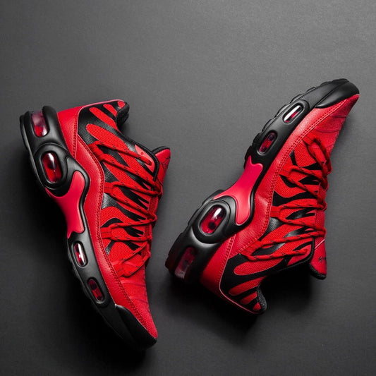 Red and black high-top sneakers on a dark gray background