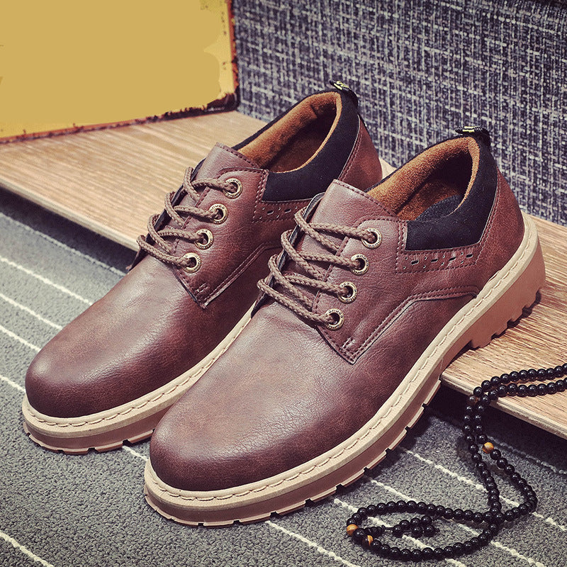 Brown leather shoes on a textured surface with a vintage sign in the background