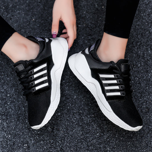Black and white running shoes worn by a person on a dark textured surface