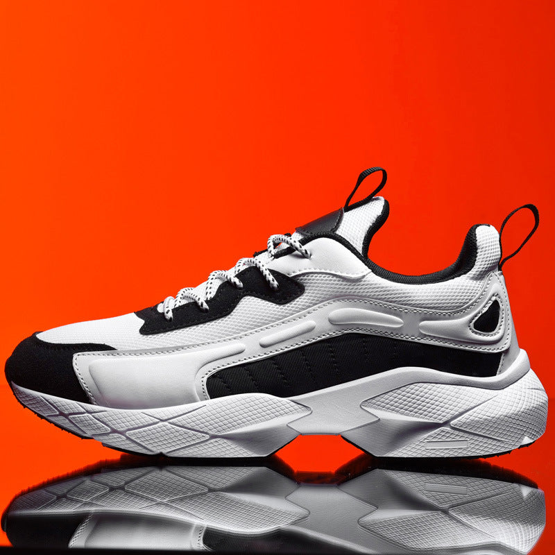 White and black sneaker on a reflective surface with an orange background