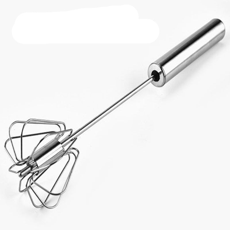 A stainless steel egg beater with a semi-automatic design, featuring a long handle and a whisk attachment, resting on a wooden surface.