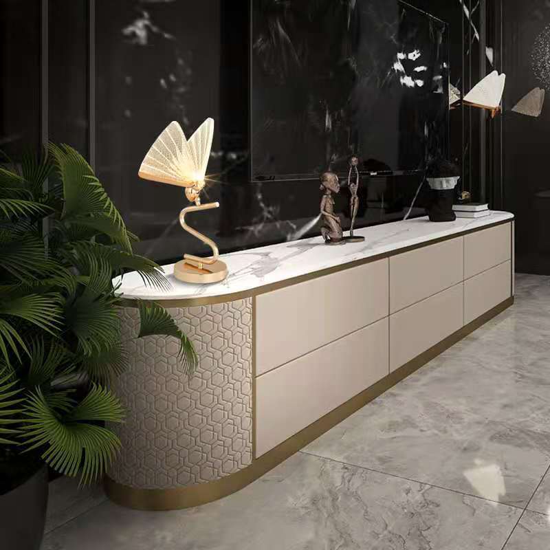 Modern TV stand with marble top and geometric design in a stylish room.