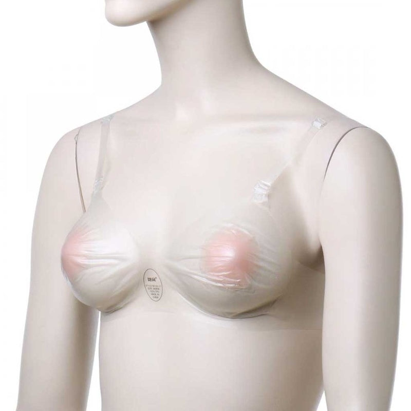 Mannequin with breast form on plain background