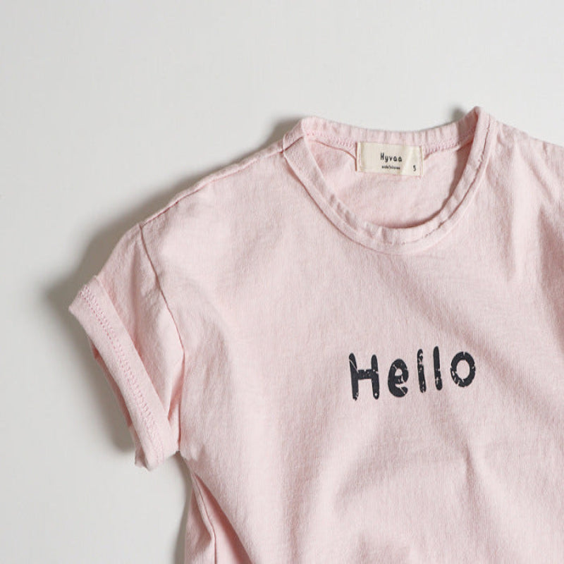 Pink t-shirt with 'Hello' text on a light gray background
