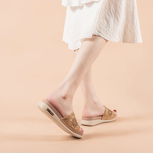 Beige sandals worn with a white dress on a beige background