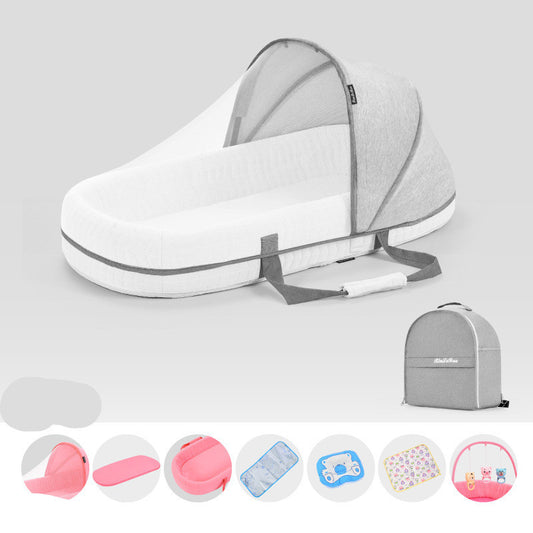 Baby bassinet with accessories on a light gray background