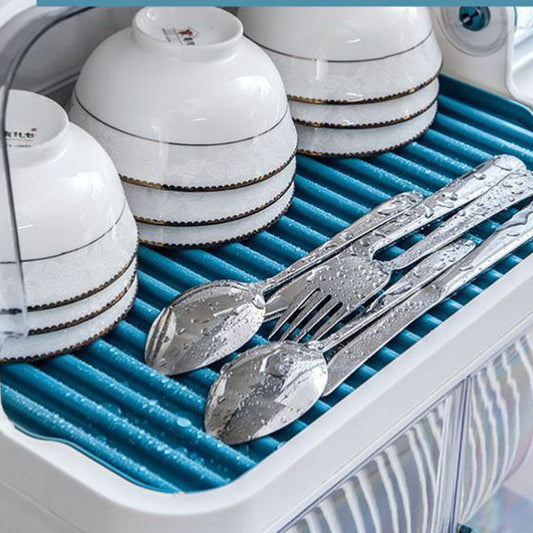 Dish dryer with white bowls and silver cutlery on a blue mat.