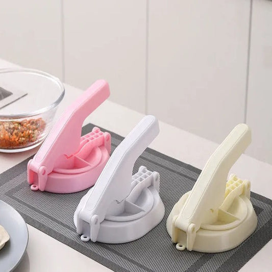 Three kitchen gadgets on a countertop with a neutral background