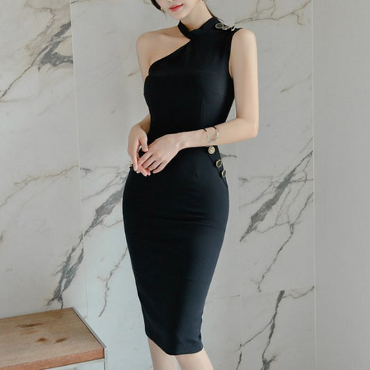 Woman wearing a black dress against a marble wall.