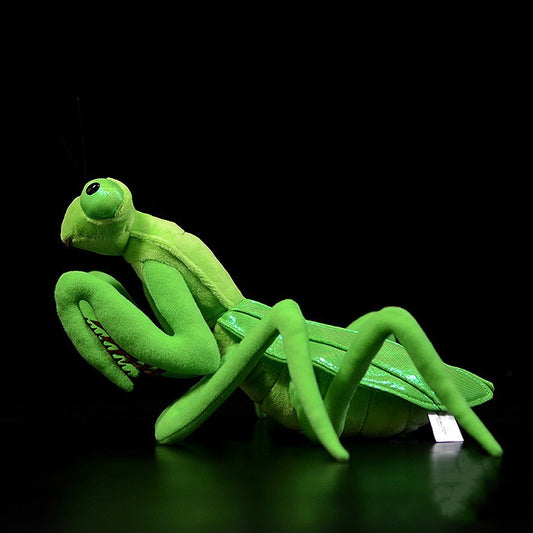 Green plush mantis toy on a black background