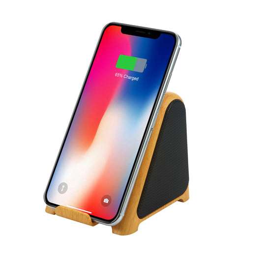 Smartphone charging on a wooden stand with a white background.