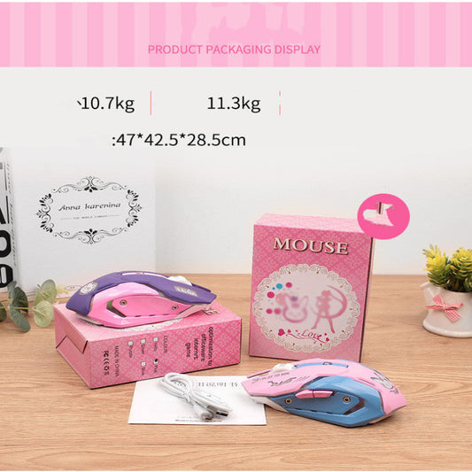 Pink and blue computer mice with packaging on a wooden surface.