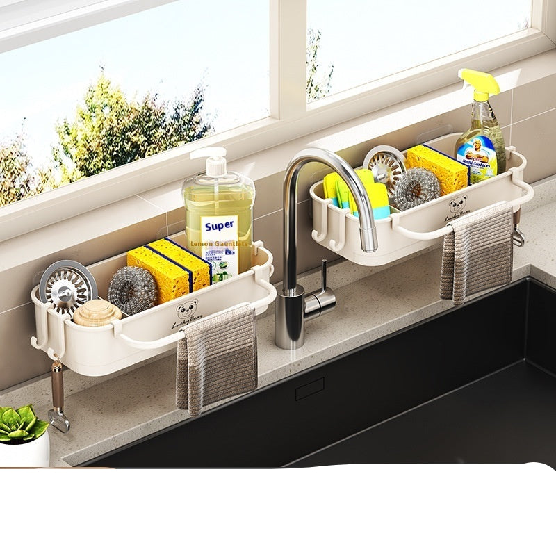 Creamy white sponge storage rack with kitchen items on a windowsill.