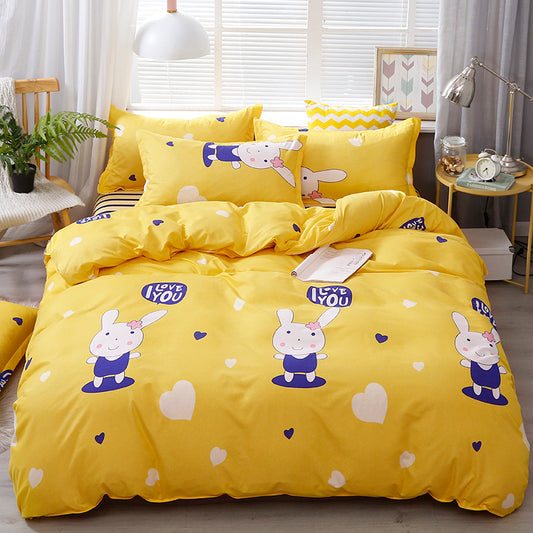 Yellow bedding set with cartoon rabbit design in a bedroom.