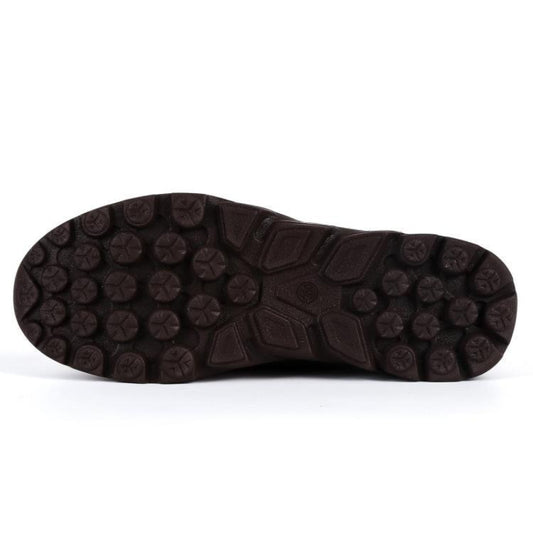 Close-up of a brown shoe sole with tread pattern on a white background