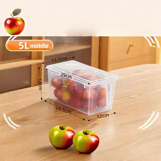 A clear plastic fridge storage box containing apples, placed on a wooden surface, with dimensions labeled as 29cm by 15.5cm by 12cm.
