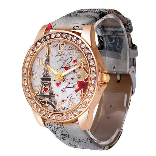 Watch with decorative face featuring Eiffel Tower and hearts on a white background