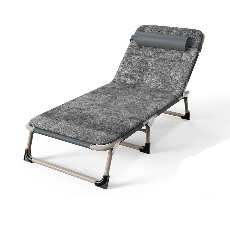 Gray folding bed with pillow on a white background