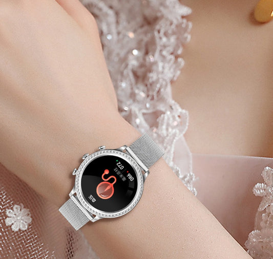 Silver smartwatch on a wrist with a blurred decorative background
